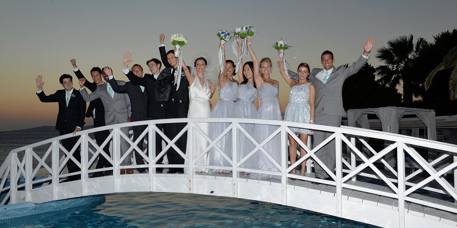 Mykonos | Japanese-Romanian Destination Wedding 25 A joyful wedding party celebrating a Japanese Romanian wedding at Saint John resort in Mykonos, by Rogdaki Events