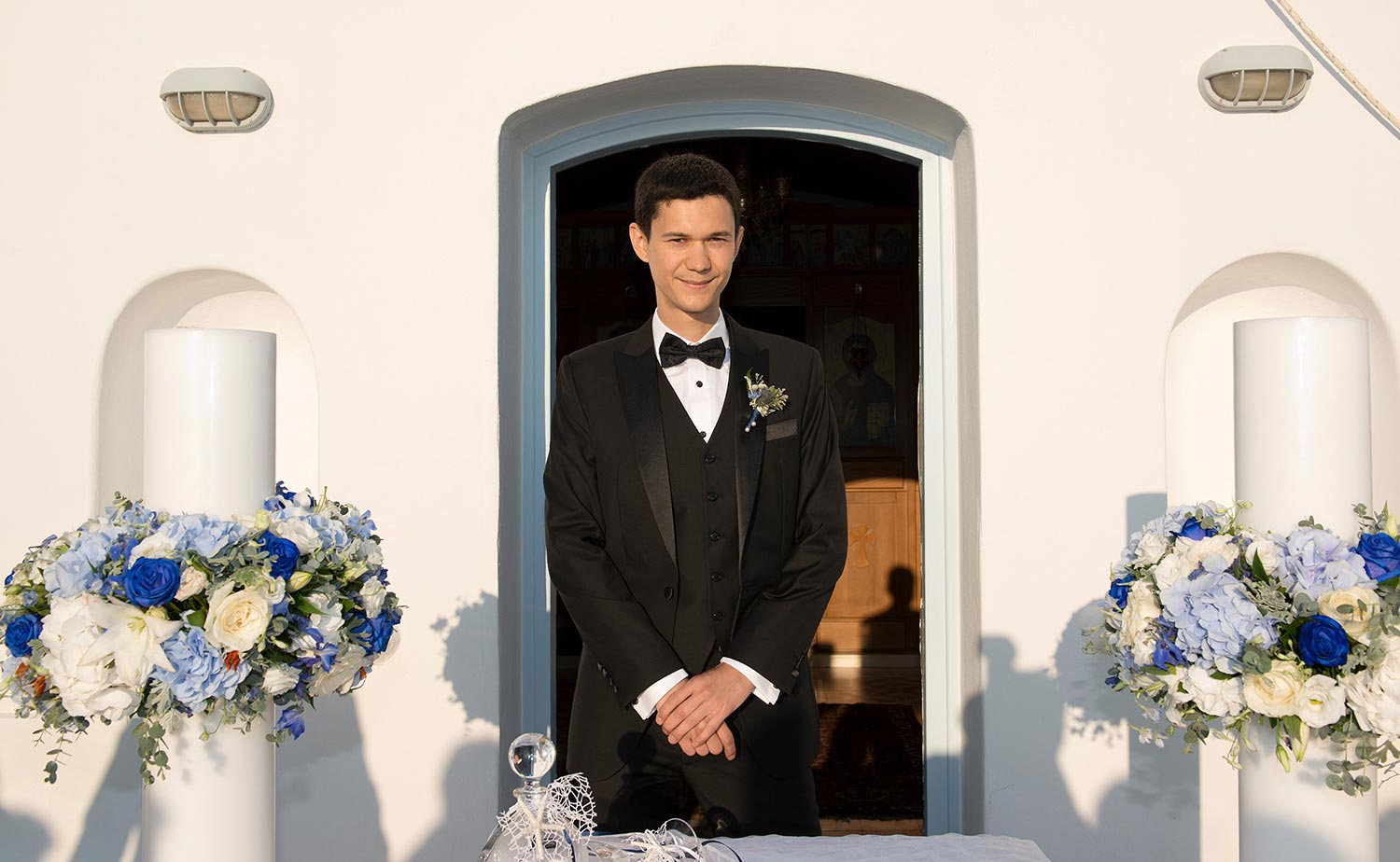 Mykonos | Japanese-Romanian Destination Wedding 18 The Japanese groom awaiting his bride at Saint John Mykonos, curated by Rogdaki Events.